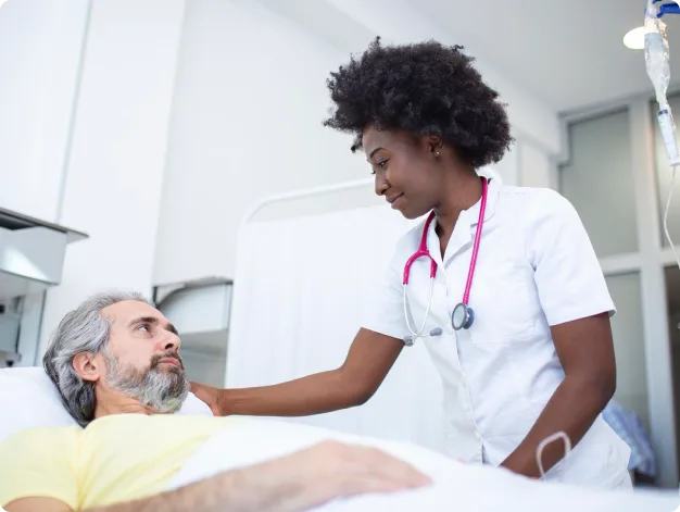 Clinician providing bedside care to a patient after hospital discharge